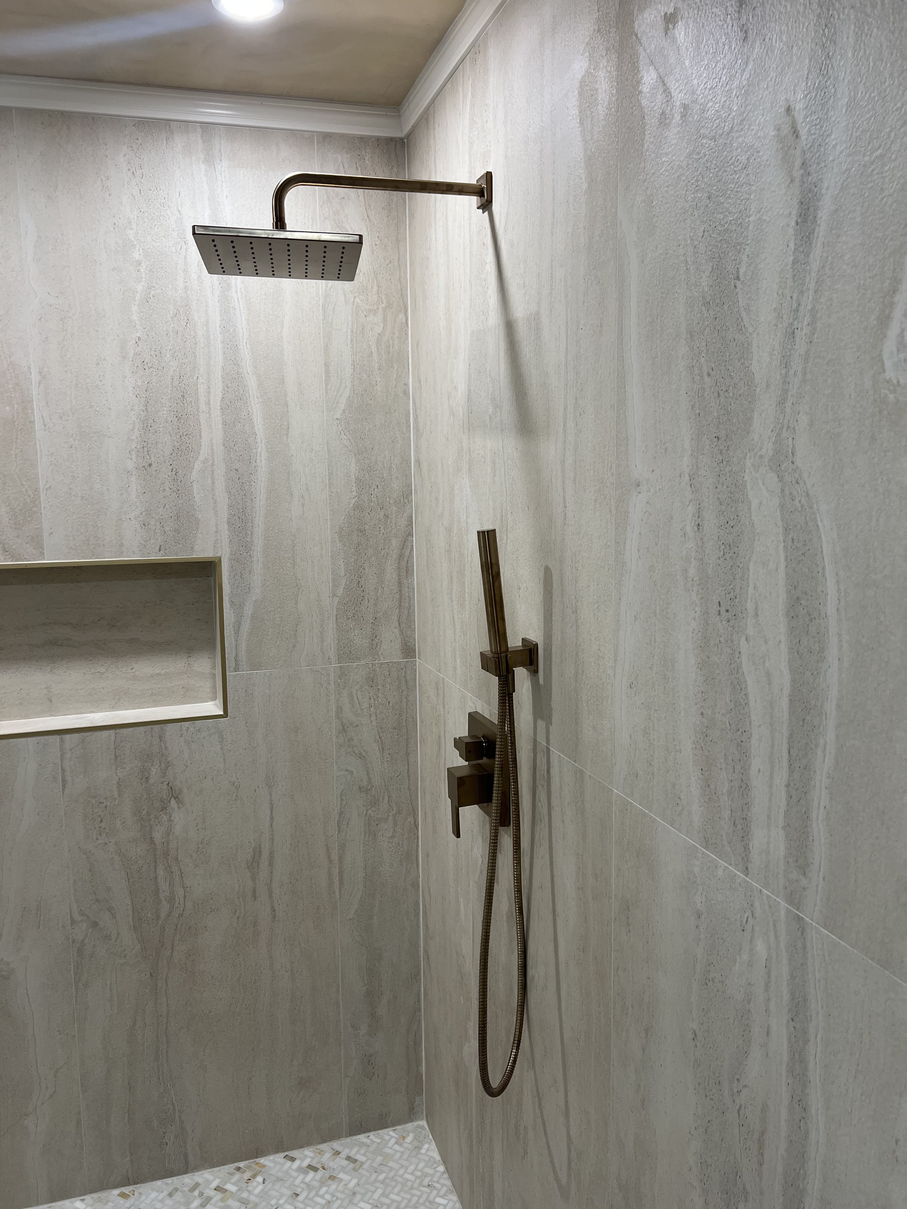 Modern walk-in shower with bronze fixtures